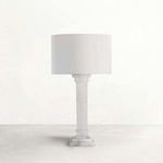 Tall table lamp with a white marble column base and a simple cylindrical white fabric shade