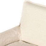Detail view of cushioned seat and armrest junction with soft natural linen fabric wrap