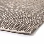 Close-up angled view showing woven recycled PET yarn texture on Darla rug edge