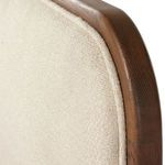 Close-up where headboard upholstery joins the smoked oak frame showing fabric texture and wood grain