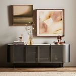 Lifestyle view showing media console styled with decorative objects and wall art in living room