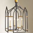 Close-up view highlighting the gilt finish details and candle-style light bulbs inside the black frame
