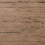 Close-up overhead view focusing on fine wood grain and subtle texture of rustic oak table top