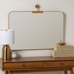 Rectangular orientation of the mirror mounted horizontally on wall above mid-century wood console