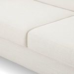 Close-up of seat cushions with white textured fabric and subtle piping details