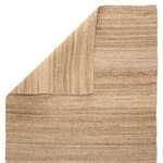 Rug corner lifted to reveal natural fiber weave on reverse side with consistent tan hues