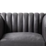 Close-up on plush vertical channels on backrest with smooth dark gray leather texture