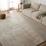 Rug laid in bright living room with beige sofa and natural light from window