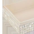 Interior view of one open box showing smooth light beige lining inside with decorated exterior