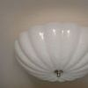 Close-up view of Rosehill Large Semi-Flush Mount scalloped glass bowl and polished metal finial from below