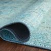 Rolled section of Loren Aqua Rug showing flexible polyester fabric and light aqua color