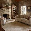 Townes Beige Clay Rug styled in a rustic living room with stone fireplace and beige sofa