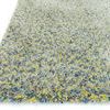 Angled close-up of rug corner highlighting mixed yarn textures and layered colors