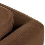 Side close-up showing armrest padding and fabric grain on seat corner