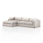 Angled shot of sectional from front left corner showing cushion arrangement and skirt detailing