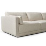 Close-up angled view of the rounded sectional arm and loose back cushion corner