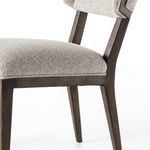 Detailed close-up of chair seat cushion fabric and the closely fitted wood frame beneath