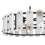 Macro detail of alabaster panes with varied veining and matte black screws on Antolini pendant