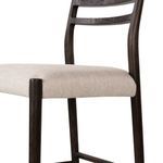 Angled close-up showing seat fabric texture and upper leg joinery to frame