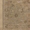 Partial top-down view of rug on light wood floor showing pattern and border detail