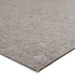 Close-up angle showing thickness and texture of the rug pad's soft cushioning surface