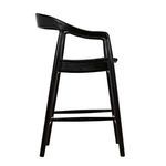 Left side profile emphasizing chair’s curved backrest and footrest bar