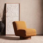 Bronwyn chair set in room setting with warm lighting, abstract wall art, and decorative black vase