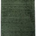 Top-down view of green rug with triangle pattern and subtle tonal variations