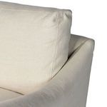Detailed view of cushion fill and smooth linen fabric on chair arm