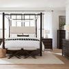 Retreat Pole bedroom set featuring chest alongside canopy bed, nightstands, and dresser in natural light room