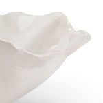 Close-up of the bowl's glossy white glaze and ruffled rim detail