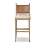 Bar stool with antique walnut frame, mahogany leather backrest with stitching, and natural linen-cotton seat