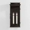 Louie Sconce front view against white wall highlighting decorative chimney top and black finish