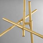 Close-up of intersecting aged brass arms in a modern chandelier design without glass shades