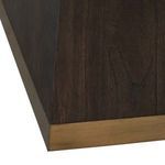 Close-up of angled base corner with visible gold-toned banding accent