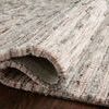 Close-up of rug edge curled to reveal dense pile and weave detail