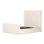 Back view of headboard with black backing, framed by beige linen slipcover stitching
