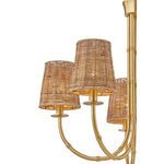 Close-up on the rattan shades and bamboo-style warm brass arms with light glowing inside shades