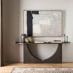 Ryder painting displayed above dark wooden console table in neutral styled living room with decorative objects