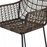 Close-up on seat and armrest showing detailed woven wicker texture and wrapping