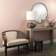 Artist Table Lamp styled on a console table with pink walls, a chair, a mirror, and floral accents in a cozy interior