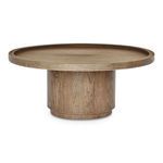 Low angle view highlighting cylindrical base and tray edge of round oak coffee table