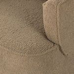 Close-up of rounded seat corner showcasing plush fabric texture