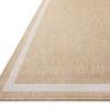 Close-up angled view of Easton Wheat Ivory rug showing flat woven texture and border detail