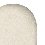 Close-up of rounded upper backrest edge with finely woven cream linen fabric