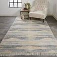 Beckett rug displayed in a room setting under a chair and side table, showing scale and placement on dark wood floor