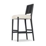 Three-quarter back angle highlighting stool's woven back and frame angles