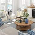Sofia Cabinet in bright living room with blue patterned pillows, round wooden coffee table, and fireplace