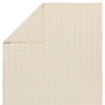 Rug flipped corner showing flat and textured sides of hand-knotted wool construction