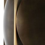 Close-up detail of brushed brass finish and curved surfaces of spherical elements on the pendant